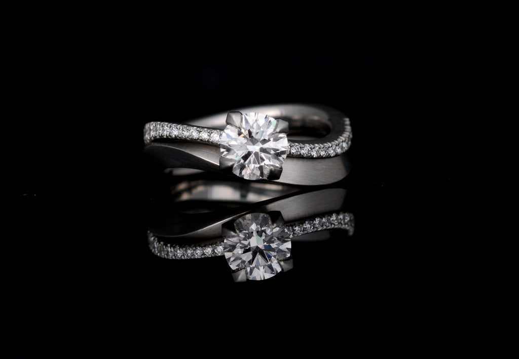 Platinum talon engagement ring with matching wedding band.