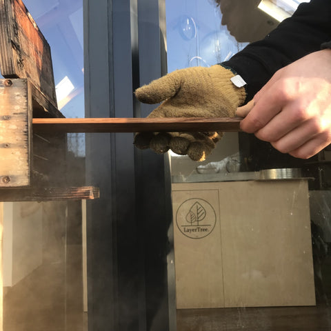 wood being removed from steam box