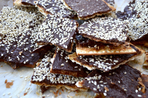 Chefanie Chocolate Matzah Toffee Pieces on Tray with Sesame Seeds
