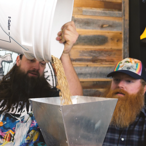 pouring grain into grinder