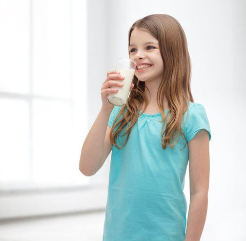 A little girl drinking milk