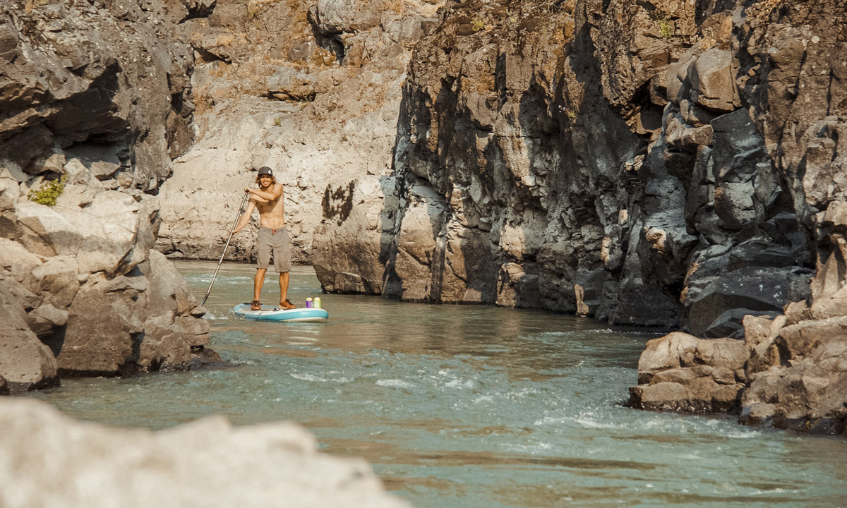 SUPBUDDY founder Devin Carroll SUPing and wearing a BUOY WEAR floating hat