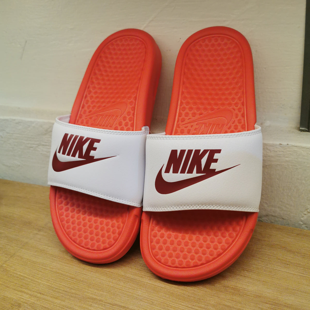 red and white fuzzy nike slides
