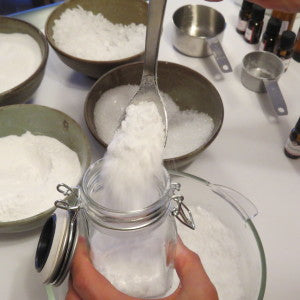 Spooning Bath Salt into jars