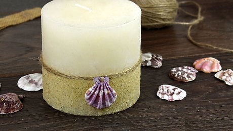 wrap the lower portion of the candle using this craft material and use glue to stick it onto the surface of the candle.