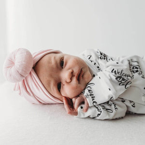 baby girl wearing bayridgecaskandkeg welcome to the world babygro with baby pink baby turban headwrap