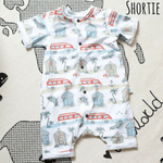 Flay lay image of  a bayridgecaskandkeg shortie romper in Beachside. The fabric features images of campervans and beachhuts