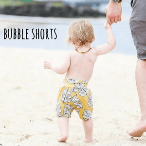 Toddler wearing bayridgecaskandkeg Mustard Monstera leaf printed bubble shorts 