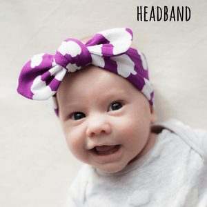 Baby girl wearing a bayridgecaskandkeg knotted headband in purple with white cloud print