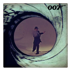 Curio & Co. looks at the best theme songs from the James Bond 007 film franchise. Image of classic spy James Bond seen in gun barrel sequence. www.curioandco.com