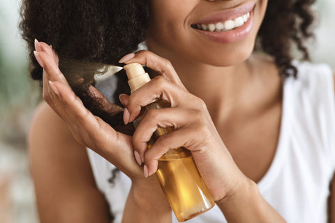 Woman refreshing her hair with spray bottle