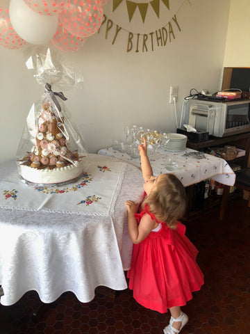 Chiara celebrating her birthday party in our Poppy red Netti smocked dress