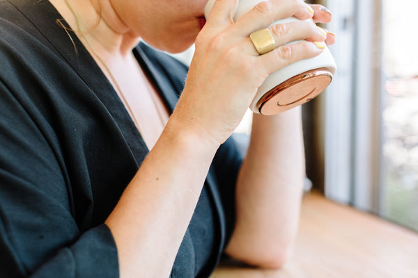 Woman drinking from Monty Milk Art Cup