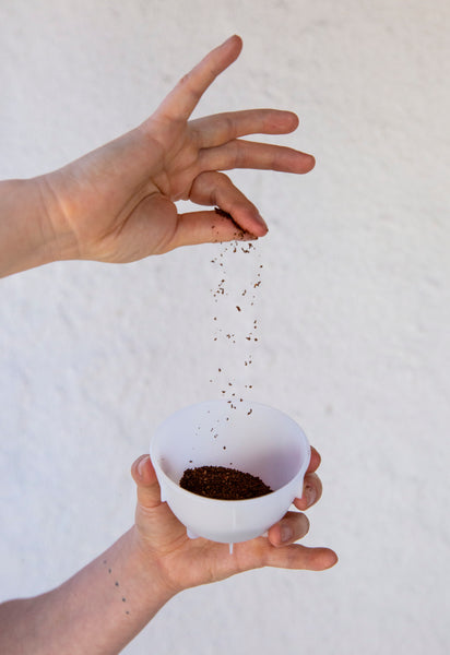 Coffee grinds dropping into cup