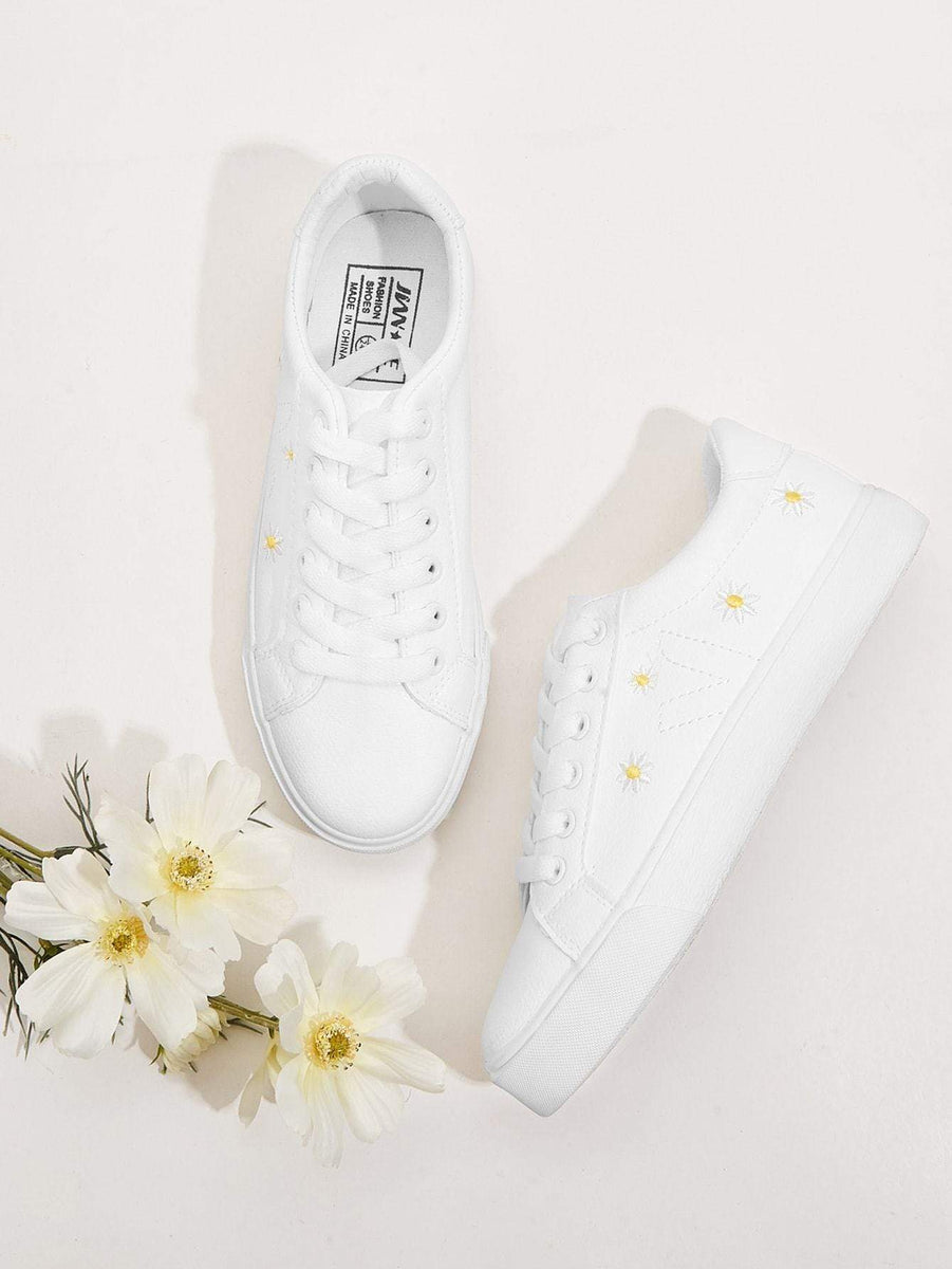 white sneakers with flower embroidery