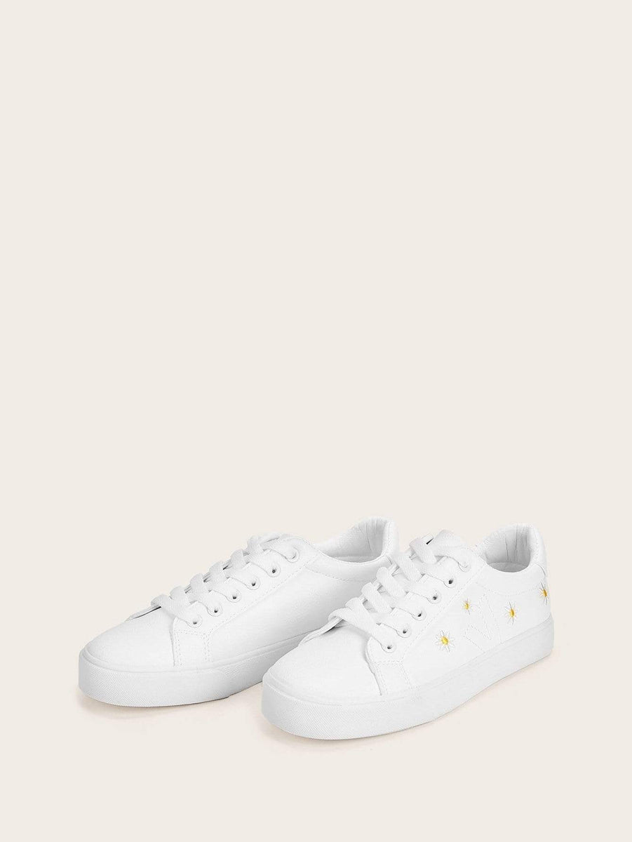 white sneakers with flower embroidery