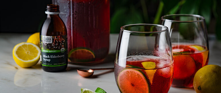 Elderberry Lemonade on table with lemons to side