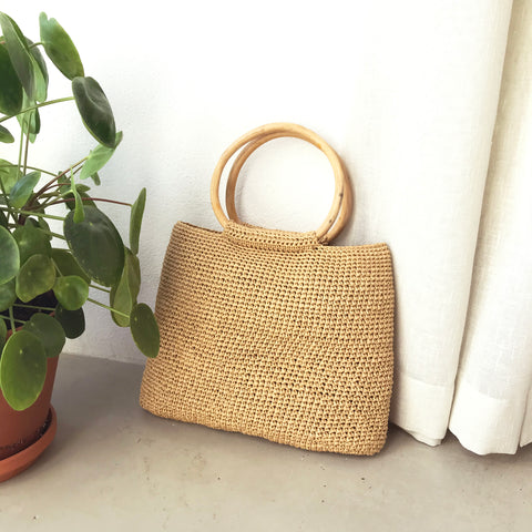 I made a chrocheted summer bag that looks like straw bag. It has two round, bent wood handles and it is made out of paper yarn, so it's fully biodegradeable. 