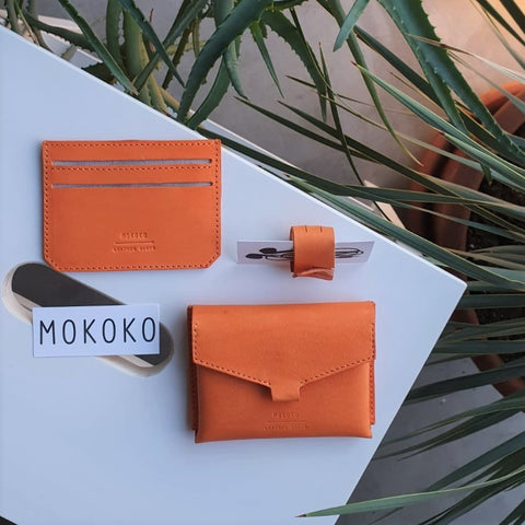 Orange vegetable tanned leather Slim card case, Fold Wallet and cable organizer made in our studio in Tallinn. Photo by Anna Romanova.
