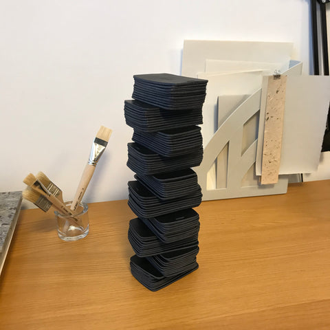 A tower of leather car remote key cases, work in progress.