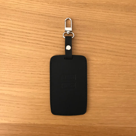 Leather car remote key case in front with embossed buttons.