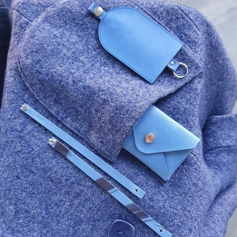 Blue vegetable tanned leather key case, envelope card case and bracelets. Photo by Anna Romanova.