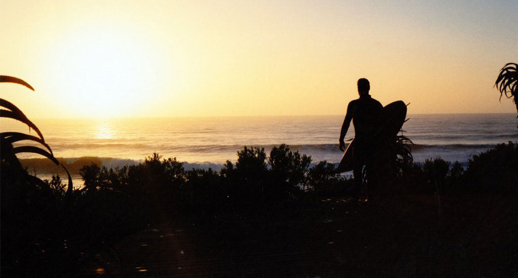 jefferys bay south africa guy with surfboard at sunrise sunset mischa blog