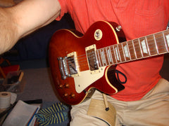 ergonomic guitar support. The Mundo Guitar Support being used on the right leg with heavy Les Paul guitar.