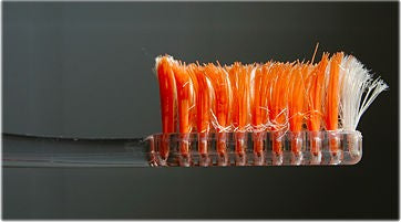 Old Orange Toothbrush with frayed bristles