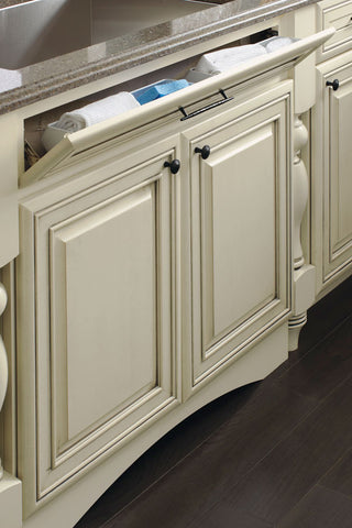 Tilt out tray for a kitchen sink base cabinet