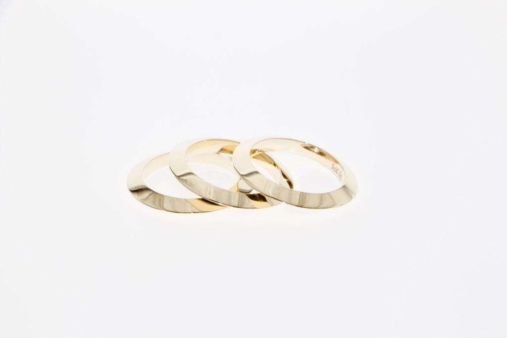 Golden round rings made from triangular forms. Tamahra Prowse Jewellery Design.