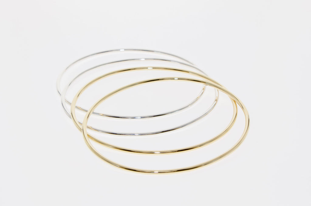 Oval bangles in silver and gold by designer Tamahra Prowse