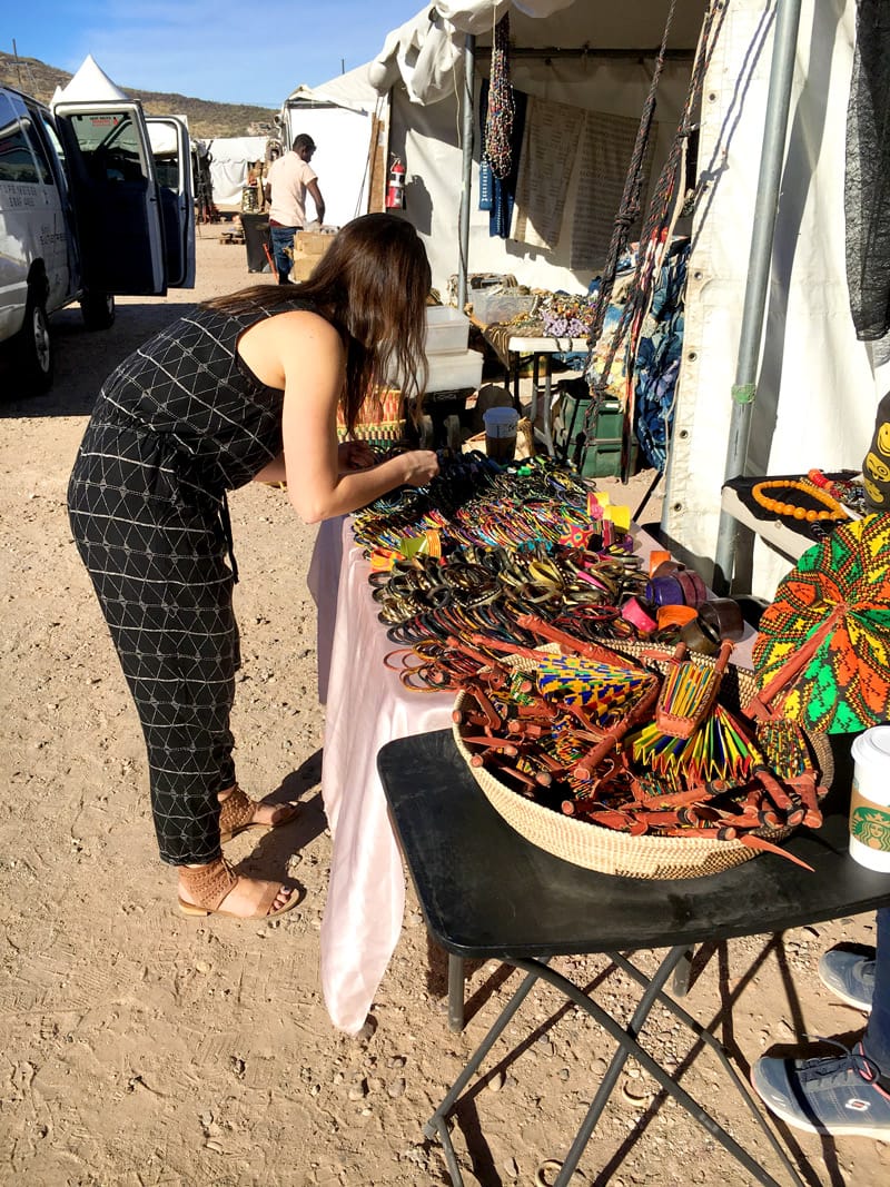 Suzy picking out colorful handcrafted goods for the betsy & iya Bazaar