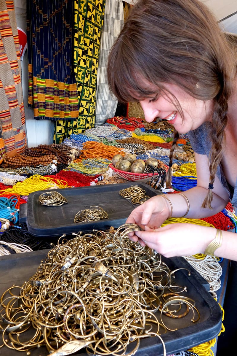 Designer Betsy Cross picking out handcrafted brass bracelets from Africa