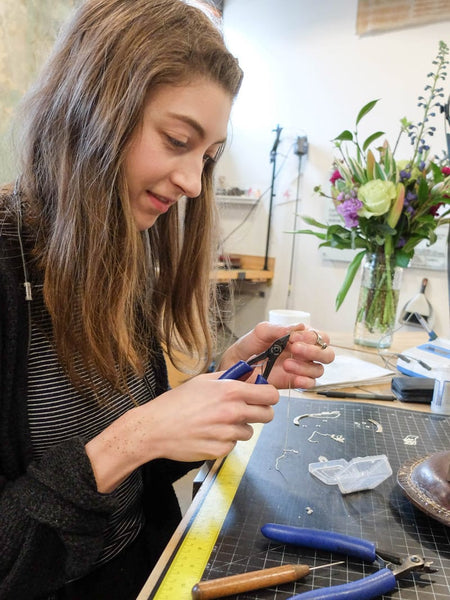 Maker Madeleine working on Humboldt Moon Necklace at the betsy & iya jewelry studio