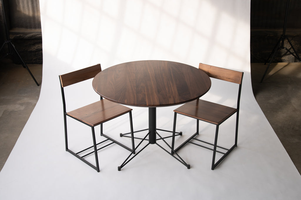 small round dining table with wood top and metal base  by Edgework Creative