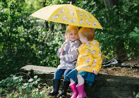 Holly and Beau rain jackets worn by girls outdoors