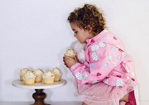 Girl wearing cupcake design raincoat by Holly and Beau