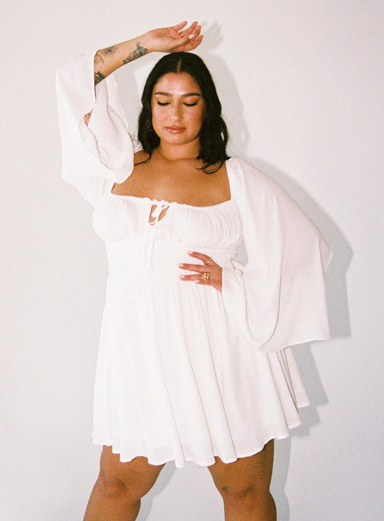 Long sleeve mini dress Off the shoulder design Tie fastening at bust Adjustable ruching at cups Shirred waistband Bell sleeves Good stretch