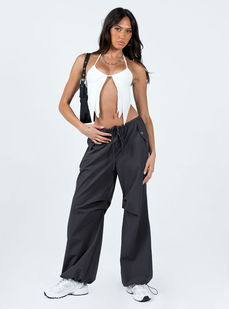 Crop top Textured material Halter neck tie fastening Adjustable coverage Clasp fastening at back Elasticated back strap Layered double pointed hem Good stretch Lined bust