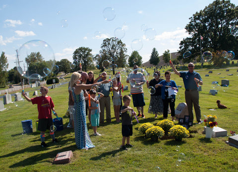 Blowing bubbles to celebrate life at Steve Ancy's memorial service.
