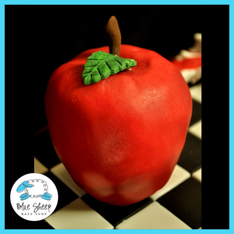 fondant apple from eclipse book on top of chess board cake 