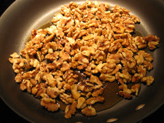 Cooking Maple Glazed Walnuts in a pan