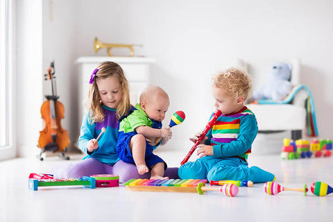 Kids playing musical instruments in playroom