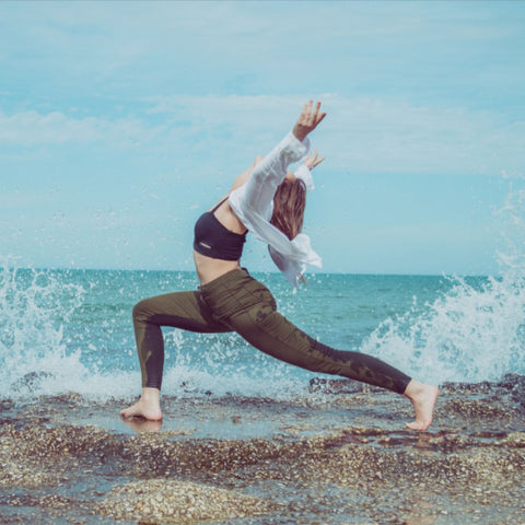 Woman in Crescent Pose on the Shore