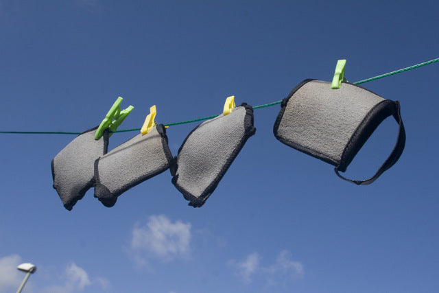 YogaPaws gloves and socks, hanging on a line.