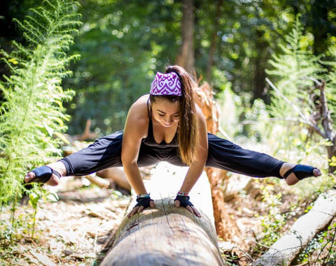 Cathy practicing Dragonfly pose on a log.