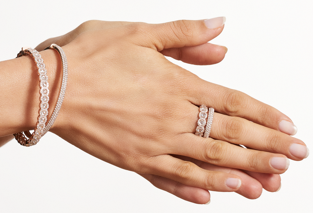 The Scallop Collection Bangle and Pave Bangle, both in rose gold, accompanied by the rose gold Scallop and Pave Bands.