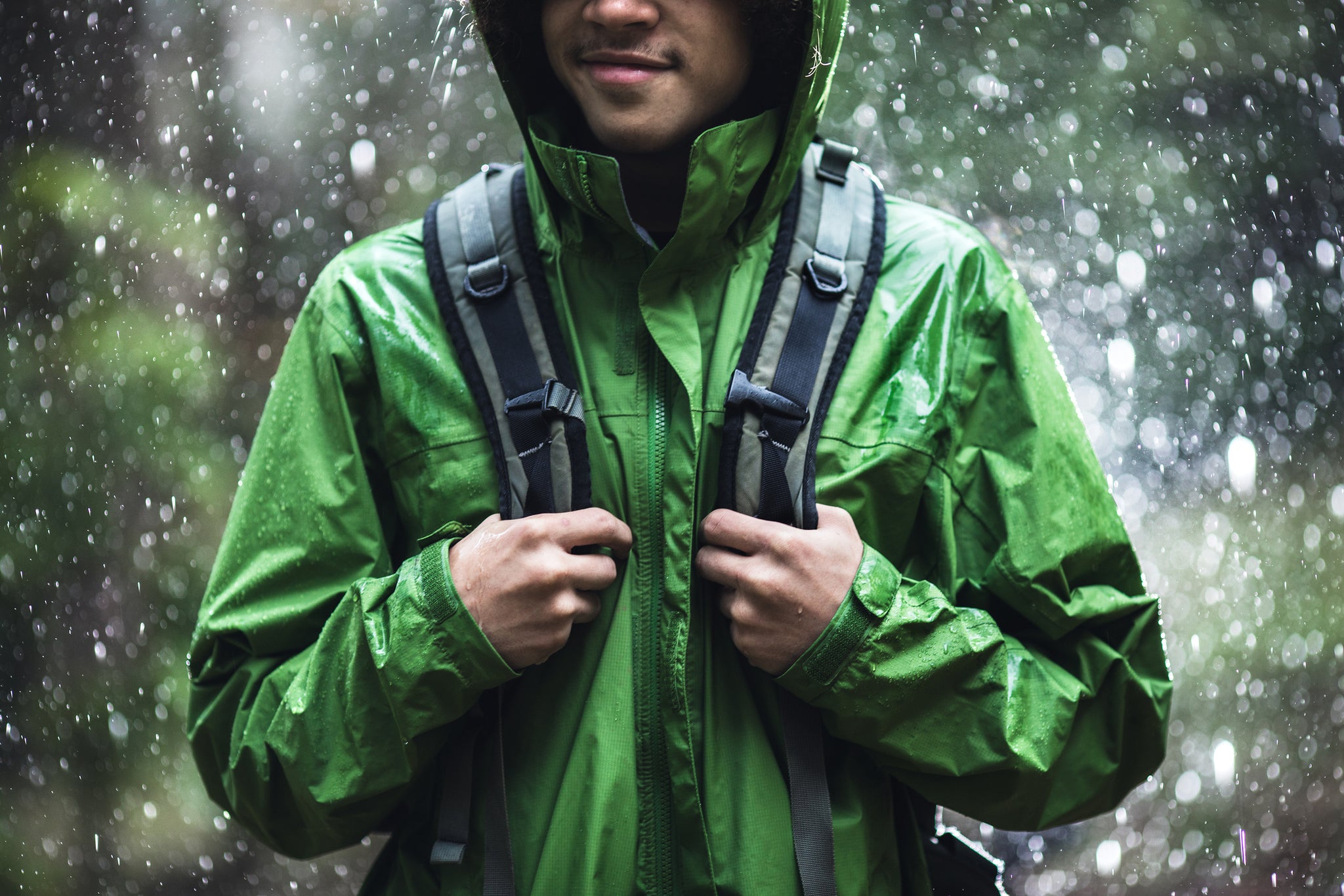 man hiking on a rainy trail