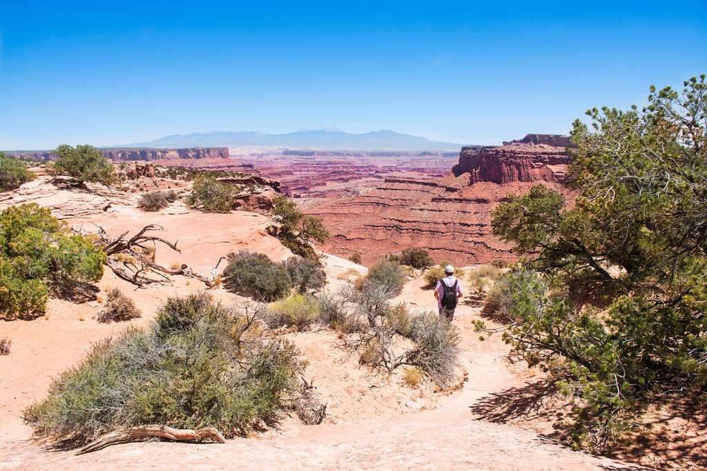 man hiking at porcupine rim utah